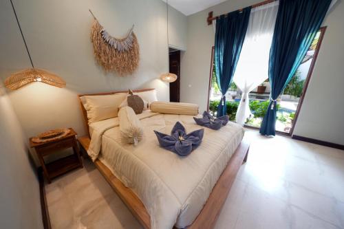 a bedroom with a bed with blue flowers on it at Villa CHANDI 2 - Legian - Seminyak - 5 Bedroom 4 Bathroom Villa - Great Location ! in Seminyak