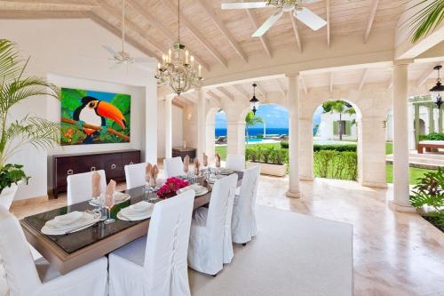 a dining room with a table and white chairs at Marsh Mellow by Blue Sky Luxury in Saint James