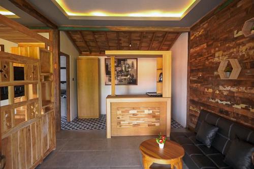 a living room with a couch and a fireplace at Green Bali Guest House in Munggu