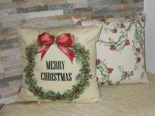 a christmas wreath pillow with a red bow at Gasthof Ramsauer in Neufahrn in Niederbayern