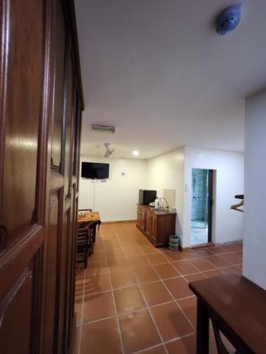 a hallway with a room with a table and a television at Uptown Eco Hotel in Kuala Terengganu