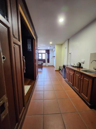 a room with a kitchen with a tile floor at Uptown Eco Hotel in Kuala Terengganu