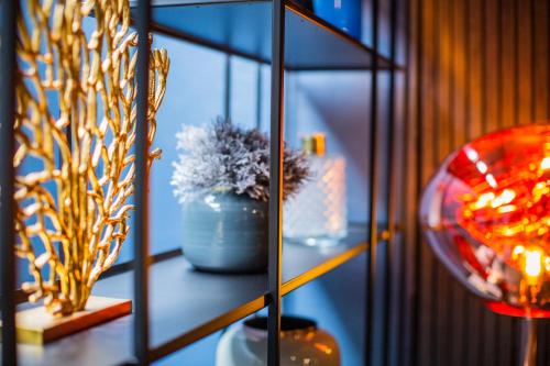 a glass shelf with a potted plant on it at Hotel du Nord Alster - auf der Uhlenhorst - SELF CHECK-IN in Hamburg