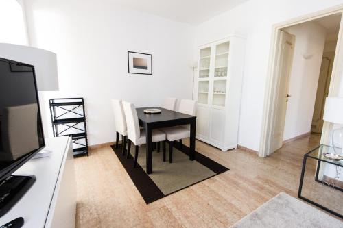 a dining room with a black table and chairs at Italianflat - Palazzo Zeiner in Verona
