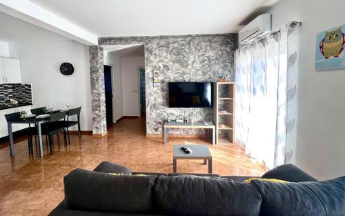 a living room with a couch and a dining room at Daisal Apartment - 2 bedroom apartment with balcony near the beach & city center, perfect for nomads, travellers, families, watersports! in Santa Maria