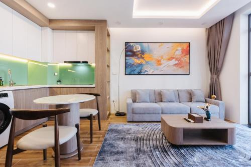 a living room with a couch and a table at Westlake Emerald Suites in Hanoi