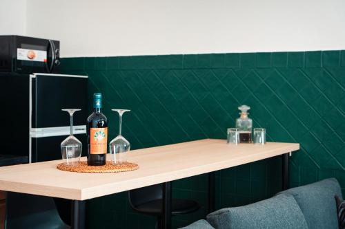 a bottle of wine sitting on a table with glasses at SambaSS Boutique Apartment in Capua