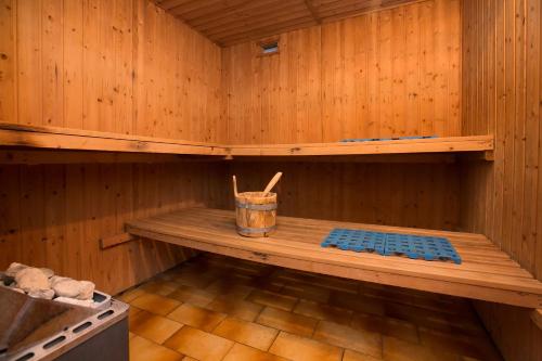 a wooden sauna with a wooden bench in it at Casa Sibylle with Sauna and Pool - Happy Rentals in Riva San Vitale