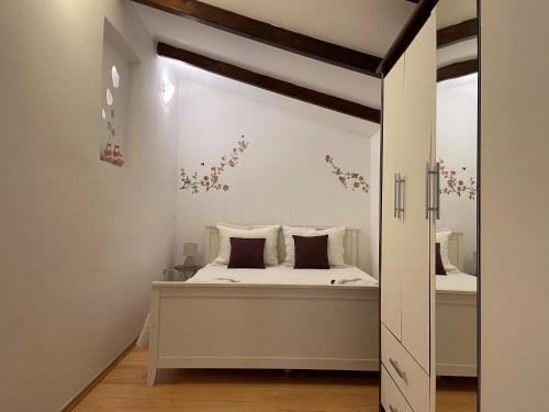 a bedroom with a bed and a mirror at Apartment Ivan in Rovinj
