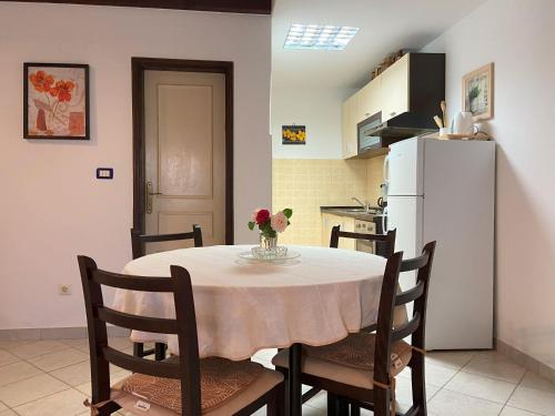 a table with a vase of flowers on it in a kitchen at Apartment Ivan in Rovinj