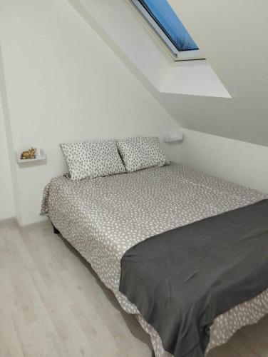 a bedroom with a bed in a white room at Maison familiale 11 personnes in Lézigné