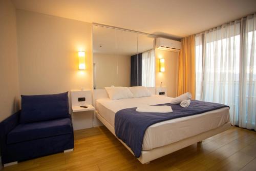 a hotel room with a bed and a chair at Orbi sity panorama in Angisa