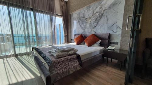a bedroom with a bed and a large window at Admiral Elite Residence in Alanya