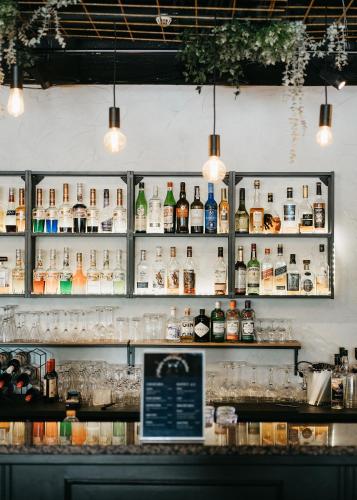 a bar with bottles of alcohol on the wall at Hotel Waltikka in Valkeakoski