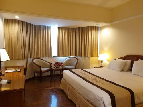 Postel nebo postele na pokoji v ubytování Ramana Saigon Hotel