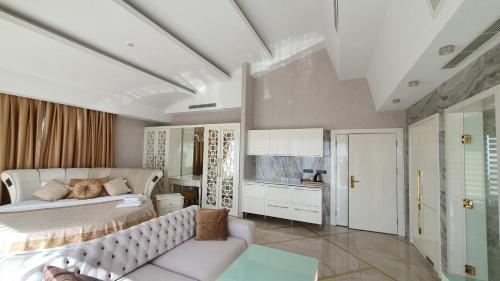 a bedroom with a large bed and a desk at Admiral Elite Residence in Alanya