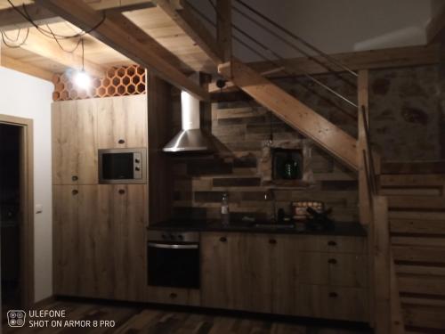 a kitchen with wooden walls and a stove top oven at Casa do casal POIOS in Pombal
