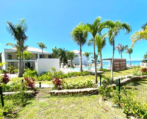 a view of a house with palm trees at Tahiti Beach apartment in Paea