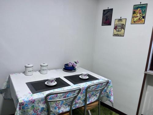 a table with two chairs and two cups on it at Casa Piemont in Casale Monferrato