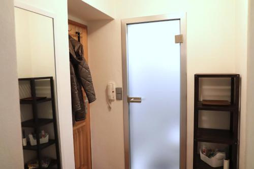 an open door to a closet with a coat at Apartmán U Parku in Olomouc