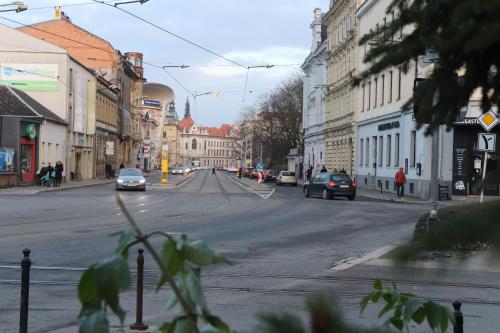 a city street with cars driving down the street at Apartmán U Parku in Olomouc