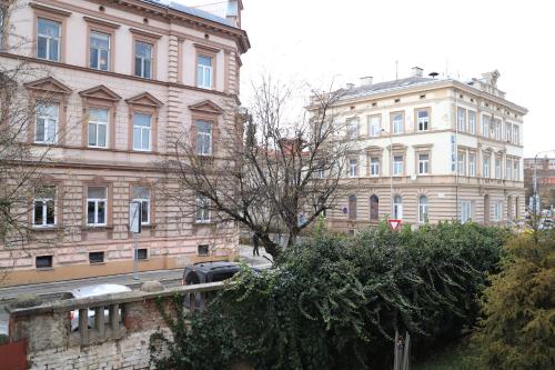 a group of buildings on a city street at Apartmán U Parku in Olomouc