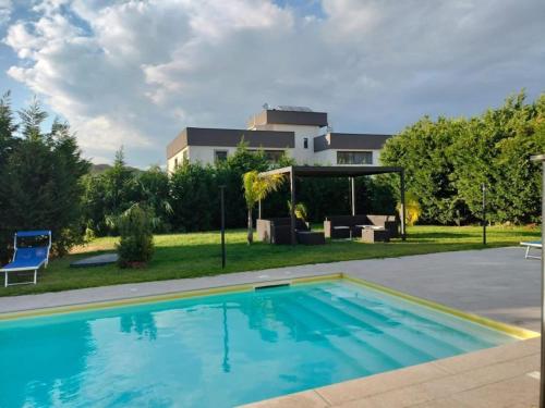 a swimming pool in front of a house at San Michele Apartments&Rooms in Catanzaro