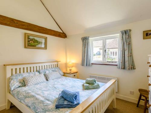 a bedroom with a bed and a window at 1 bed in Shaftesbury 52108 in East Knoyle