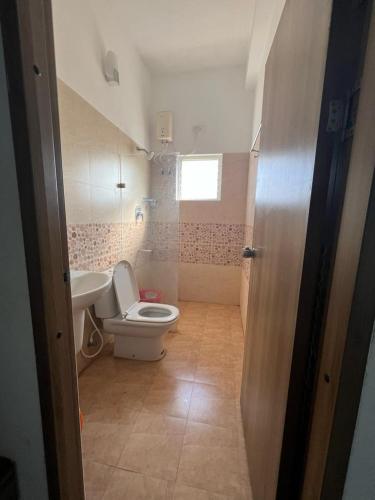 a small bathroom with a toilet and a sink at Villa 15 - 2 BHK villa in Pondicherry in Marakkānam