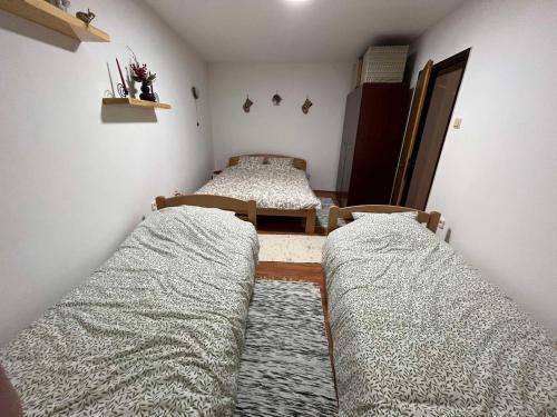 a bedroom with two beds and a table and chairs at Apartman Cogan - 100m from Gondola - Brzece in Kopaonik
