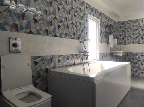 a bathroom with a sink and a toilet at HOTEL SG HUB TOWER in Margherita