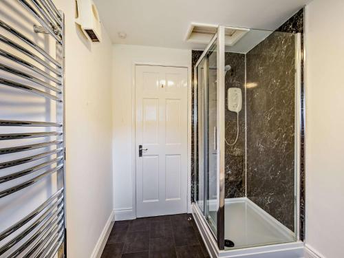 a walk in shower in a bathroom with a glass shower stall at 1 Bed in Keswick 86246 in Rosthwaite