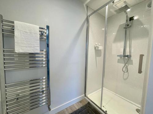 a bathroom with a shower and a glass shower stall at Blakes Beach House Humberston Fitties in Humberston