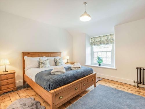 a bedroom with a large bed and a window at 3 bed in Corwen 86266 in Corwen