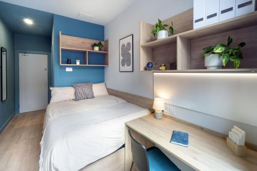 a small bedroom with a bed and a desk at Stoneybatter Place in Dublin