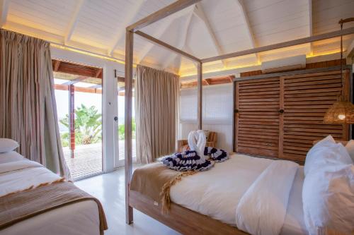 a bedroom with a large bed with a canopy at Aloha 7 in Ponta Mamoli