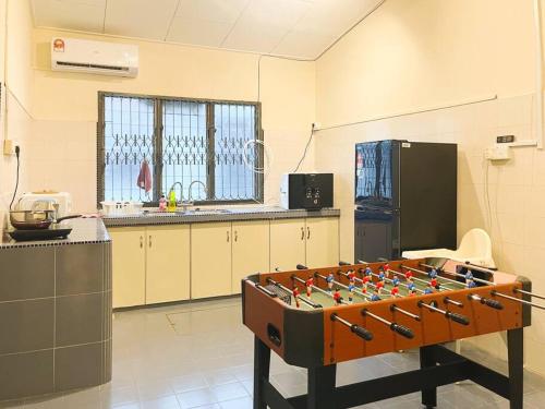 a kitchen with a game table in the middle of a room at Southkey Mid Valley , Karaoke, Table Football in Johor Bahru