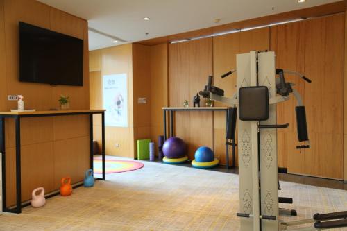 a room with a flat screen tv on a wall at Holiday Inn Express City Centre Dalian by IHG in Dalian