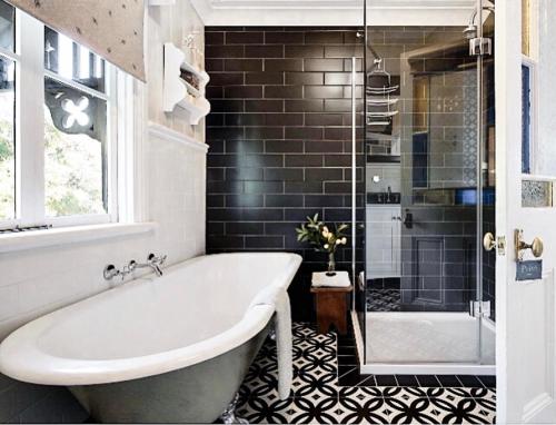 a bathroom with a bath tub and a shower at MARIGOLD COTTAGE Charming 1870s central Daylesford cottage in Daylesford