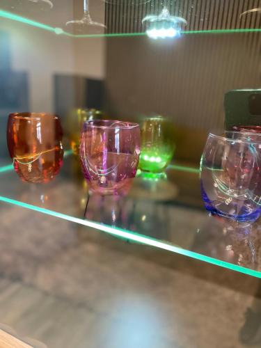 a row of wine glasses sitting on a shelf at Pension Michelangelo Stadtmitte "Netflix" in Eisenach