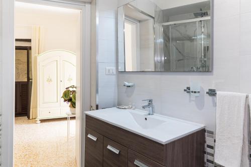 a bathroom with a sink and a mirror at LA MASCHERA DI PULCINELLA in Naples