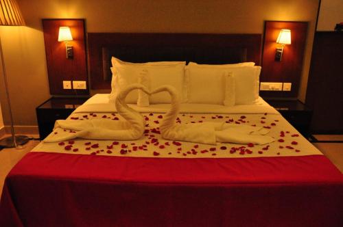 a bed with two swans made out of towels at Harbour Hotels in Pallipuram