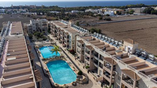 an aerial view of a resort with two swimming pools at Royal-Seacrest Paphos-Center VIP in Paphos City