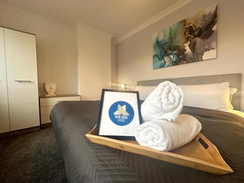 a hotel room with a bed with a tray with towels at Sandringham House by Blue Skies Stays in Middlesbrough