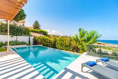 a swimming pool with a view of the ocean at Akamas Bay Villa 44 by BeCyprus in Neo Chorio