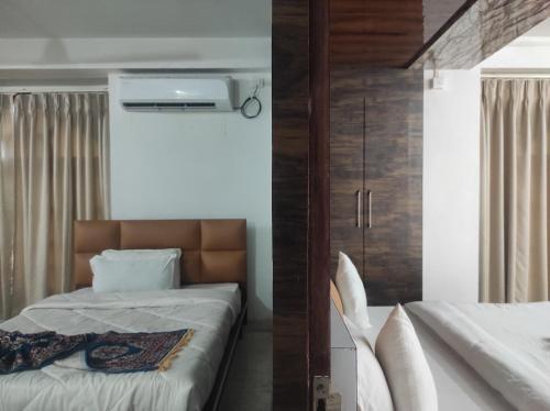 two pictures of a bedroom with a bed at HOTEL SG HUB TOWER in Margherita