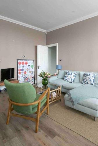 a living room with a couch and a chair at Walpole View - Pet Friendly in Margate