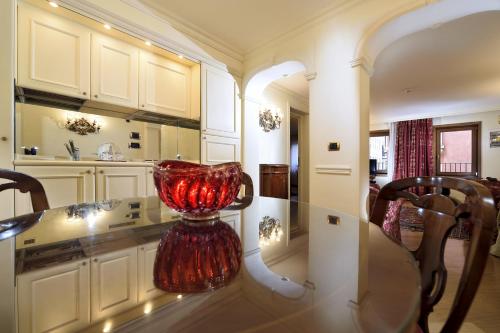 a room with a table and a large mirror at Suites Torre Dell'Orologio in Venice