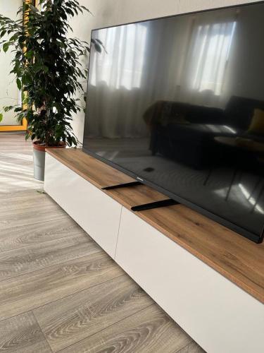 a large flat screen tv sitting in a living room at Komfortables zimmer mit wlan/HBF in Germersheim
