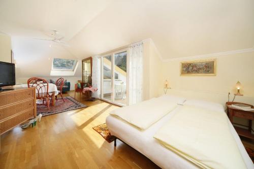 a bedroom with a large bed and a television at Hotel Tiffany in Merano